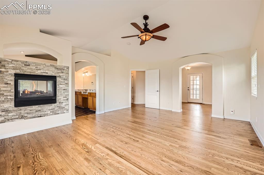 Image 19 of 48: Primary bedroom with double-sided fireplace separate sitting area/office sp