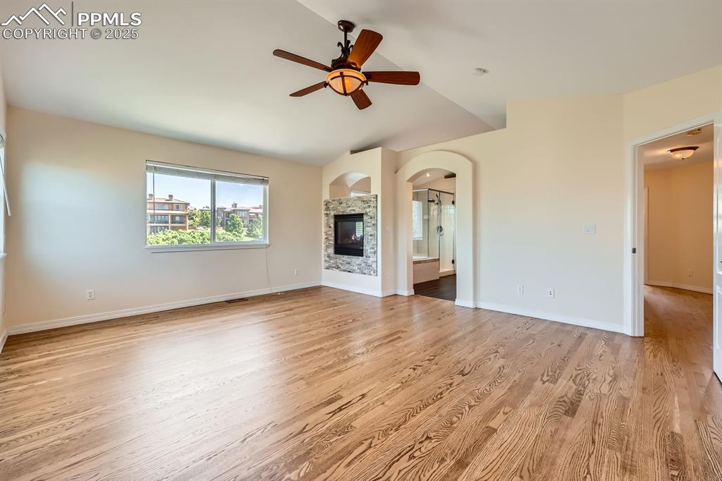 Image 20 of 48: Primary bedroom with double-sided fireplace