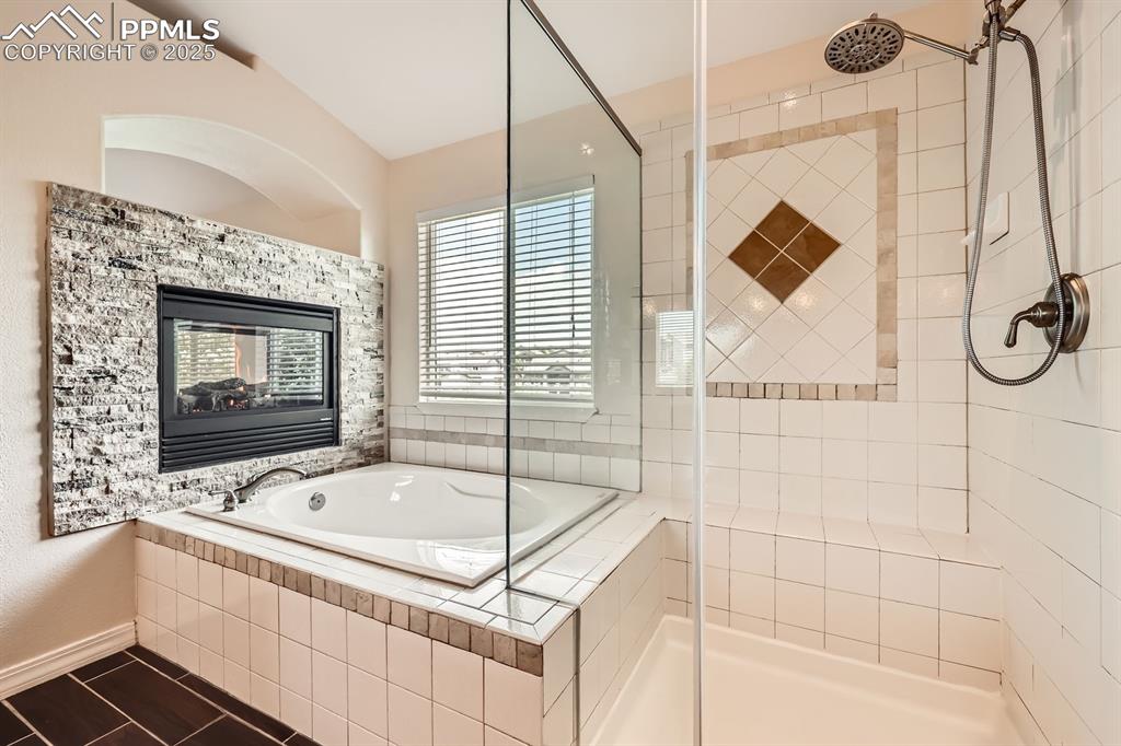 Image 26 of 48: Master bathroom with garden tub, frameless shower cabin