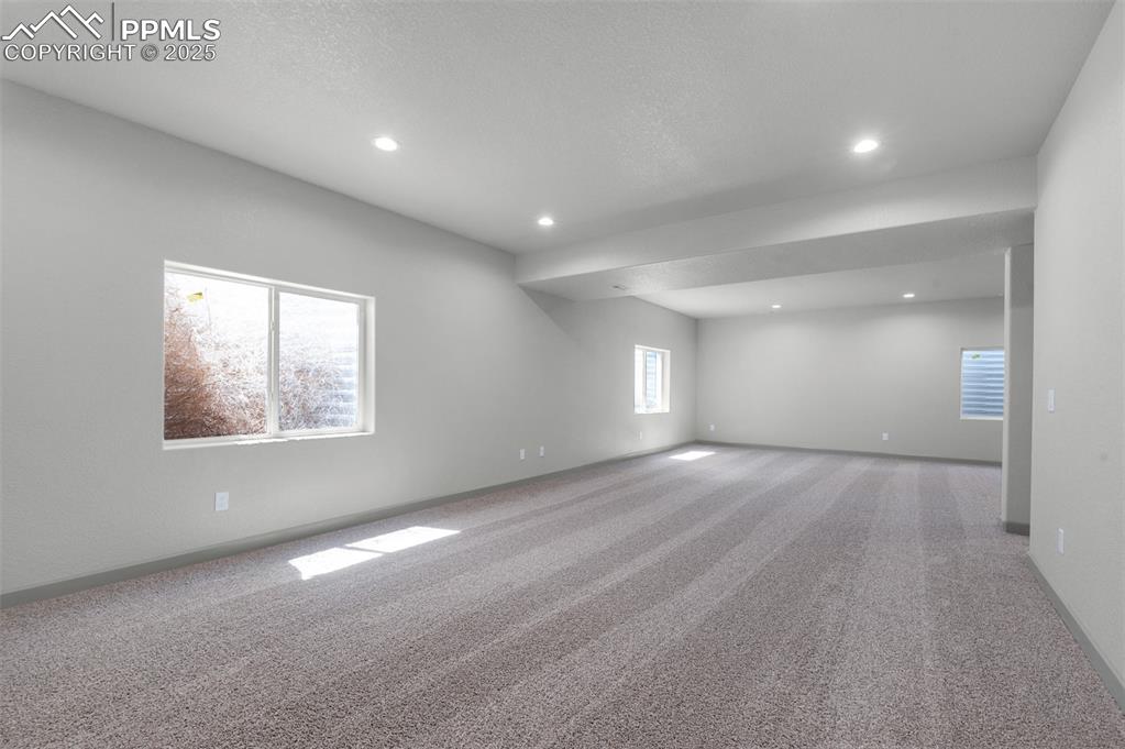 Image 16 of 21: Carpeted empty room with recessed lighting and a textured ceiling