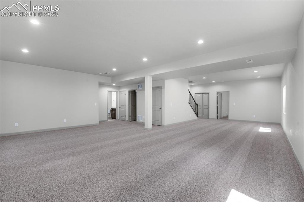 Image 18 of 21: Basement featuring carpet floors, recessed lighting, and stairway