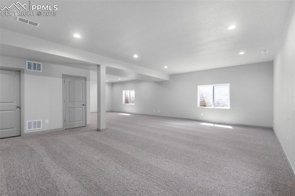 Image 19 of 21: Below grade area featuring carpet floors and recessed lighting