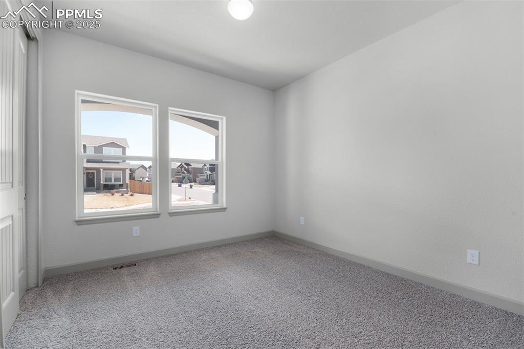 Image 3 of 21: Carpeted empty room featuring baseboards