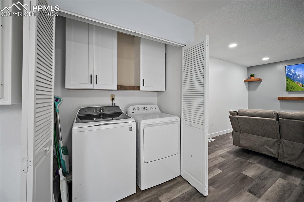 Image 15 of 38: Laundry area with cabinet space, washer & dryer