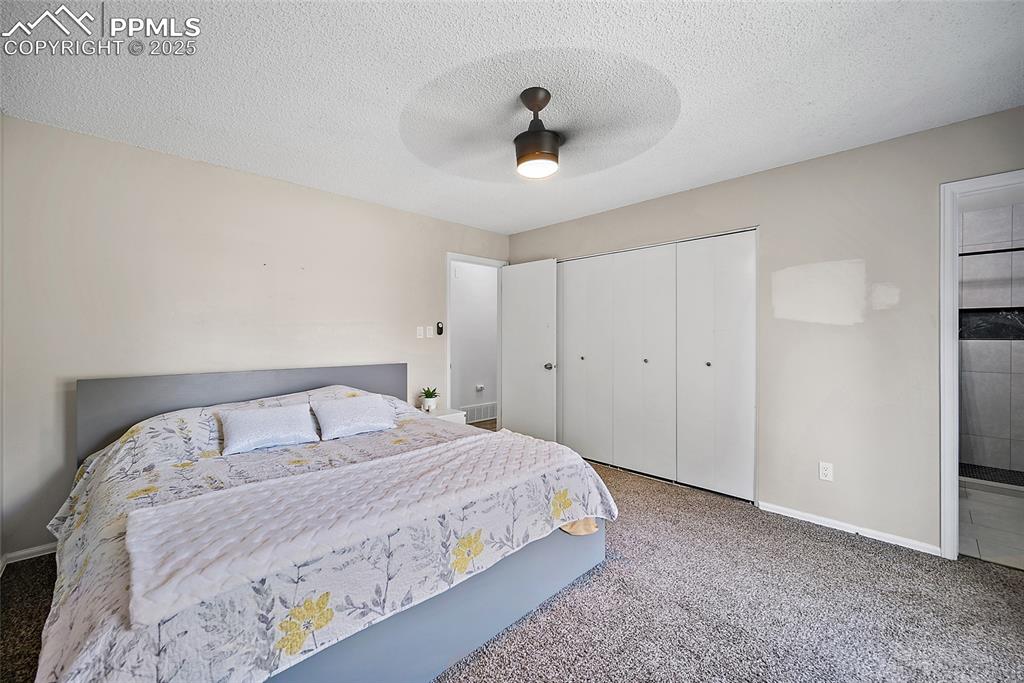 Image 20 of 38: Primary Bedroom featuring a ceiling fan, closet space and Master bathroom e