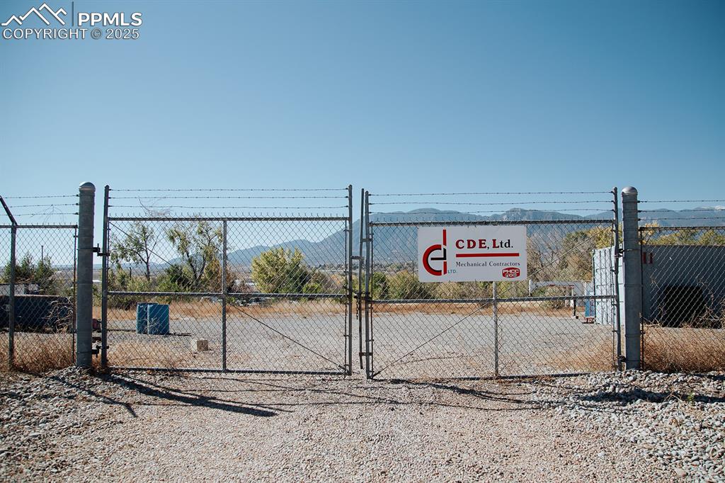Caption: View of gate featuring fence and a mountain view