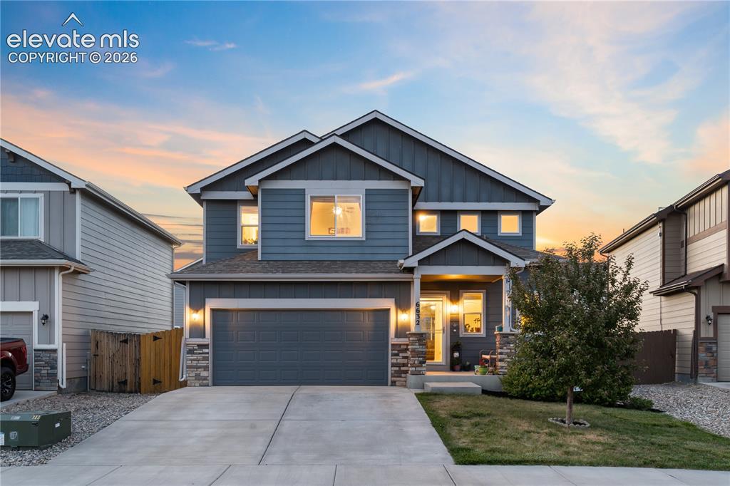 Image 1 of 43: Contemporary two-story residence featuring a two-car garage, stone façade a