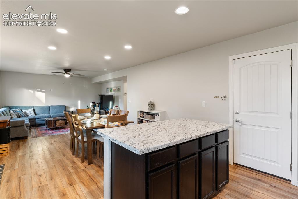 Image 21 of 43: Open-concept living space featuring wood-finish flooring, recessed lighting