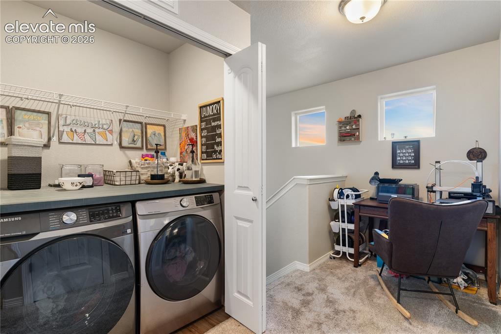 Image 24 of 43: Dedicated laundry area with countertop space and overhead shelving, washer 