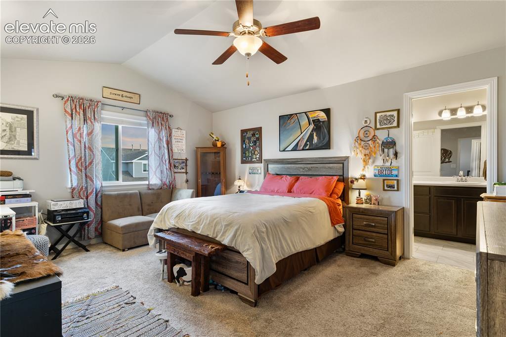 Image 26 of 43: Spacious bedroom featuring vaulted ceilings
