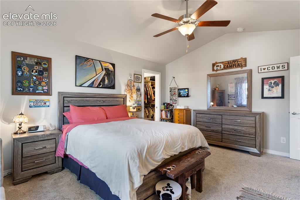 Image 28 of 43: Vaulted ceiling with a ceiling fan and light fixture
