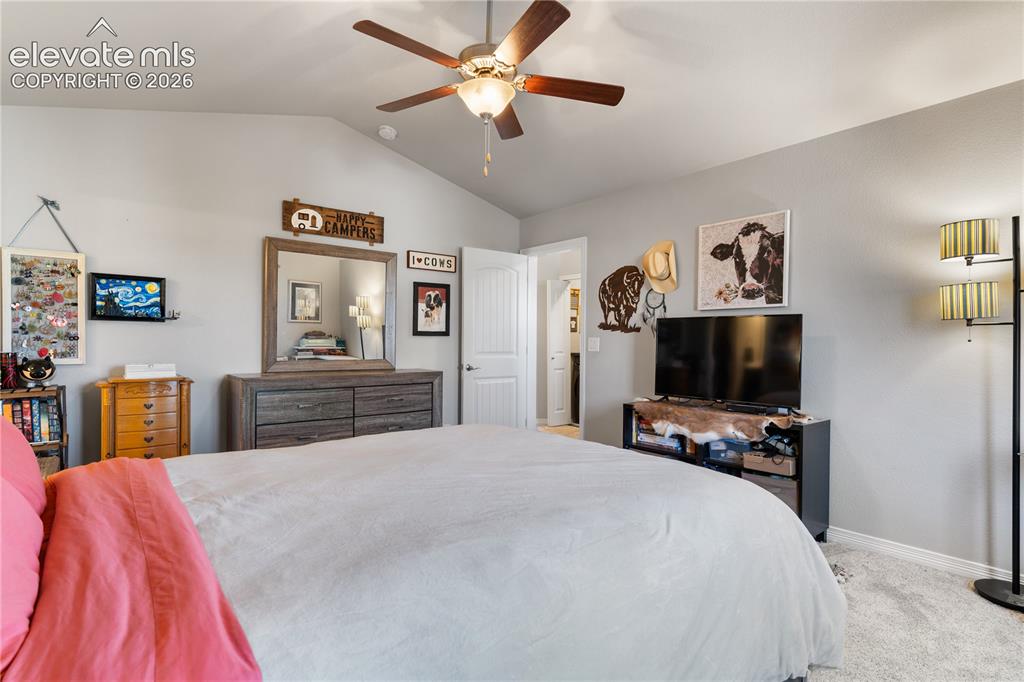 Image 29 of 43: Vaulted ceiling with a wood-finish ceiling fan and integrated lighting