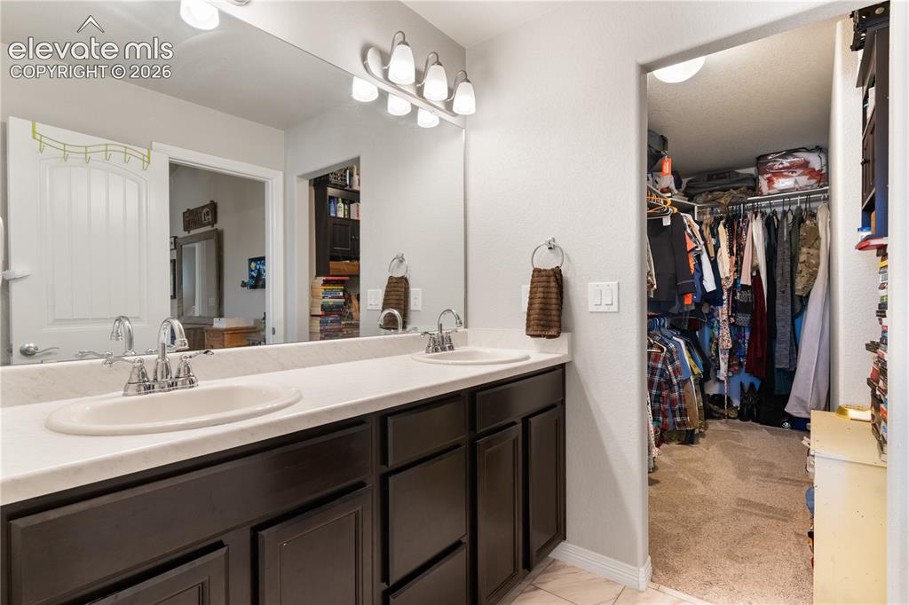 Image 31 of 43: Spacious walk in closet with upgraded closet system