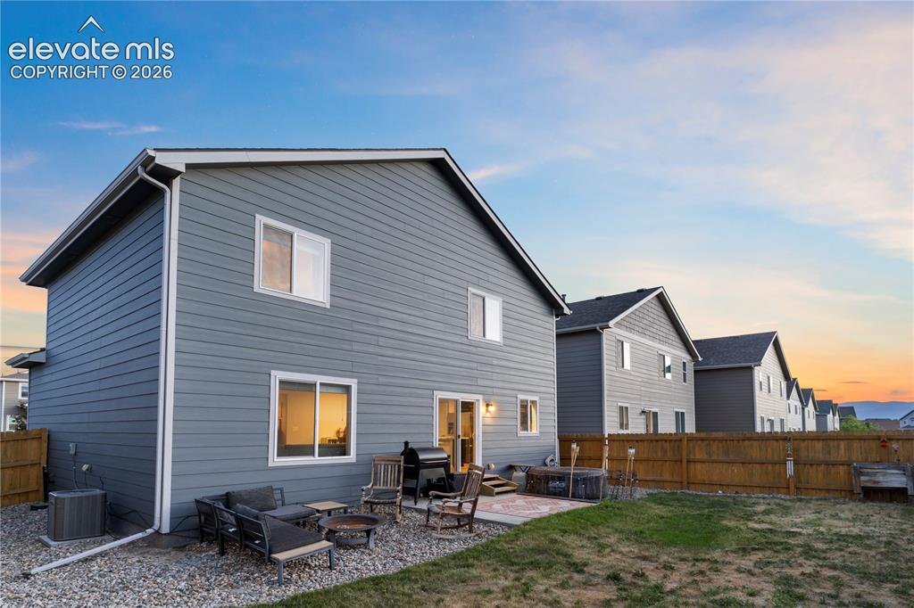 Image 38 of 43: Rear exterior featuring horizontal siding and white trim