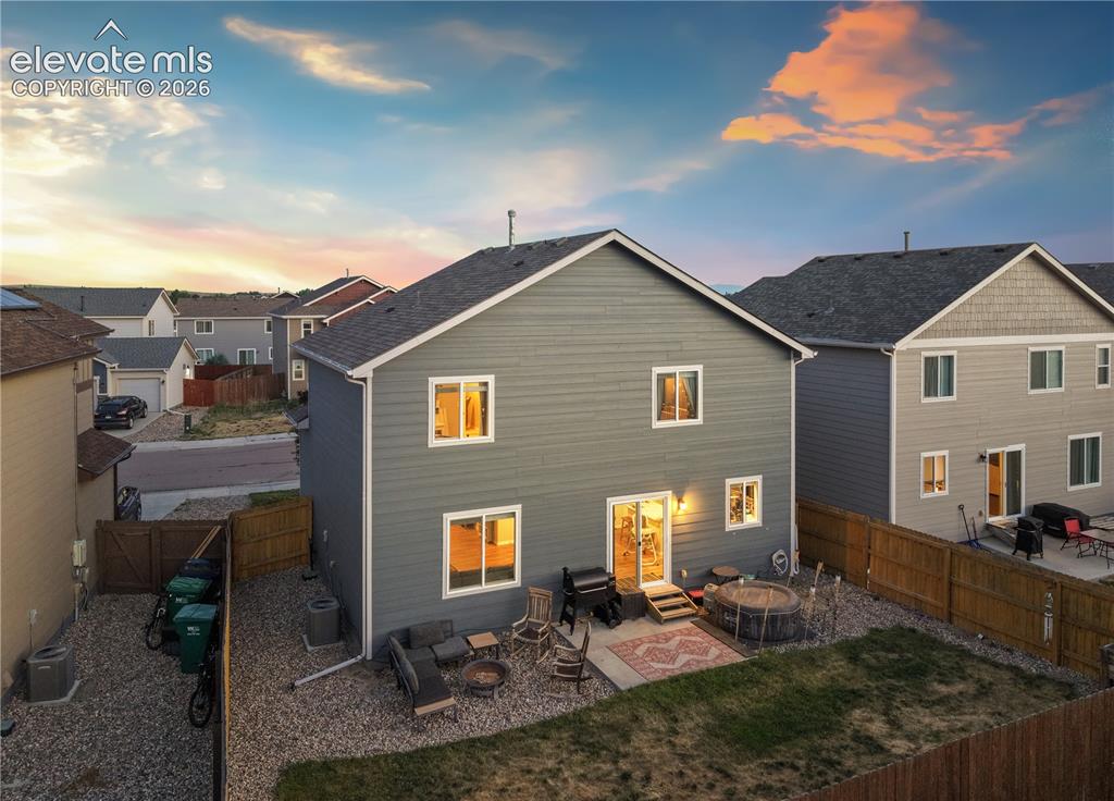 Image 41 of 43: Two-story residence featuring horizontal siding, a fenced backyard, and a c