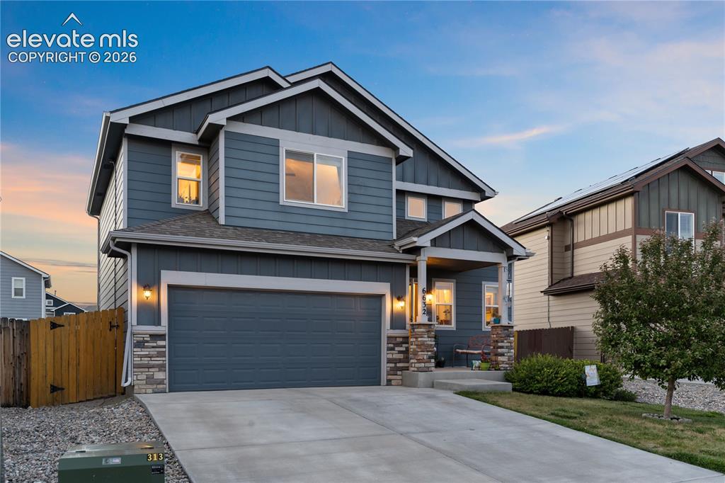 Image 6 of 43: Two-story residence featuring a covered front porch, an attached two-car ga