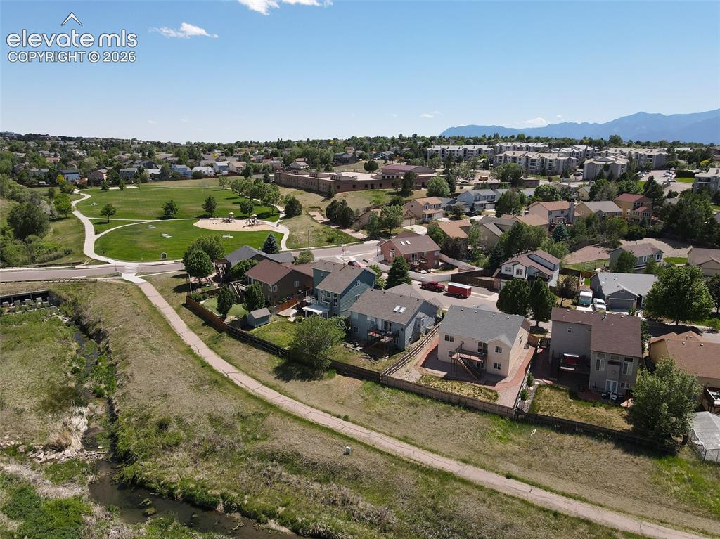 Image 21 of 27: Great open area behind the home including Homestead trail. This trail also