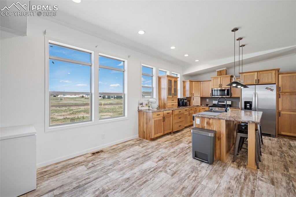 Image 16 of 34: Kitchen with appliances with stainless steel finishes, a center island with