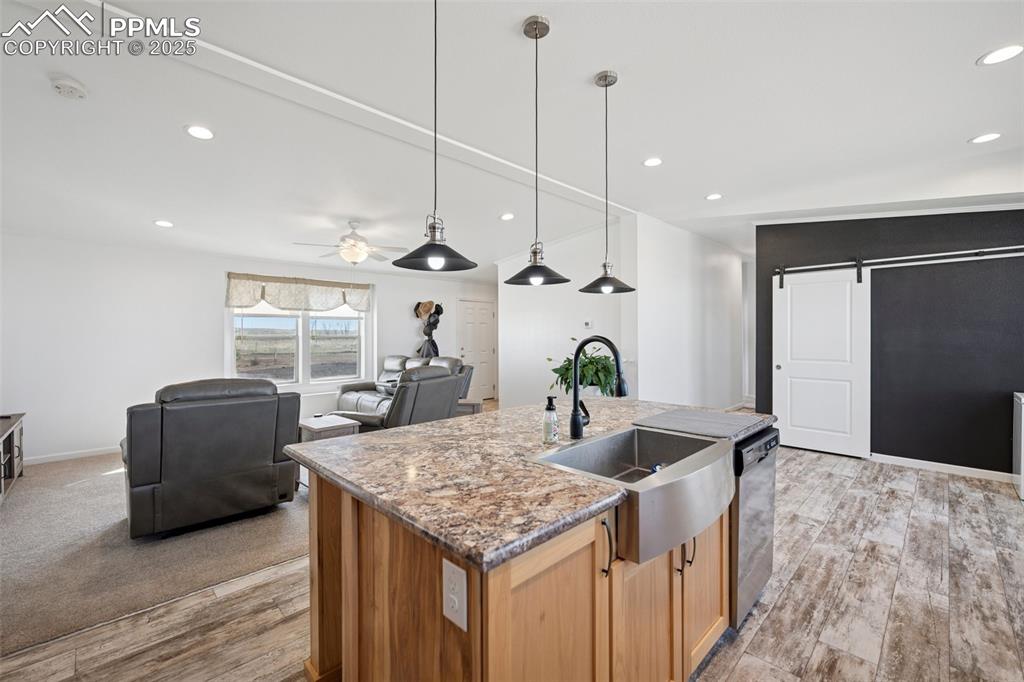 Image 19 of 34: Kitchen with a ceiling fan, stainless steel dishwasher, a sink, recessed li