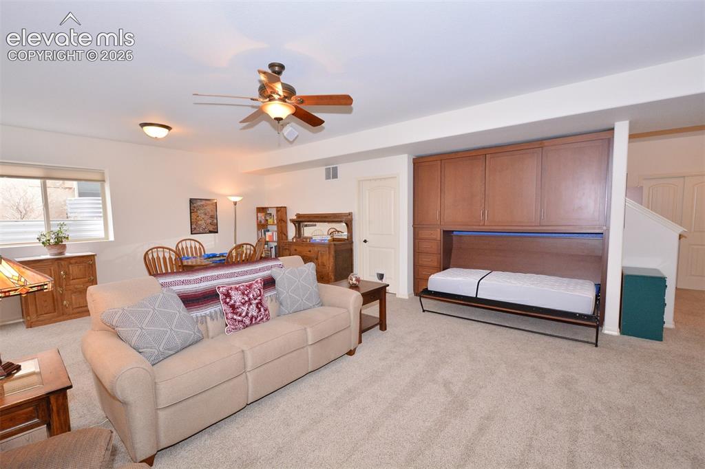 Image 24 of 45: Family room in basement with built-in murphy bed