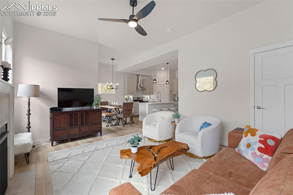 Image 12 of 42: Fireplace and ceiling fan in the living room