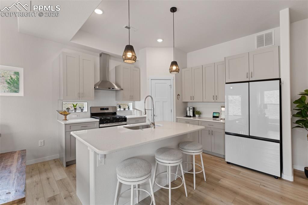 Image 14 of 42: Kitchen island has seating and a large workspace