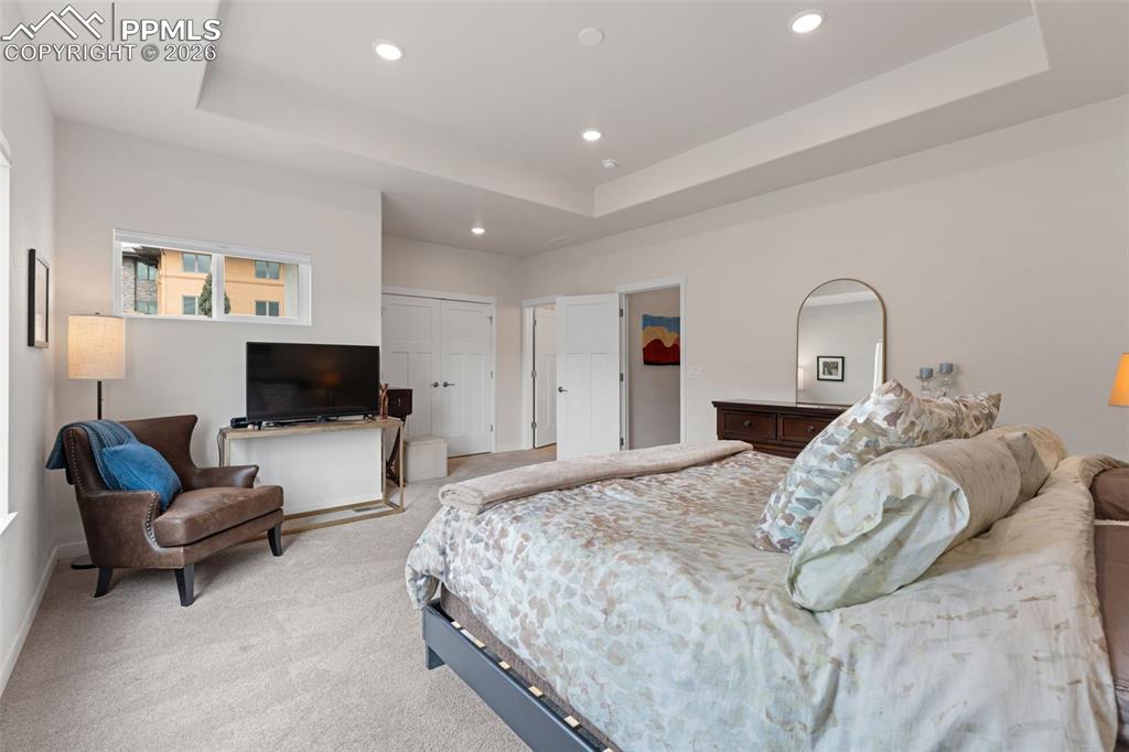 Image 17 of 42: Large primary suite has tray ceiling