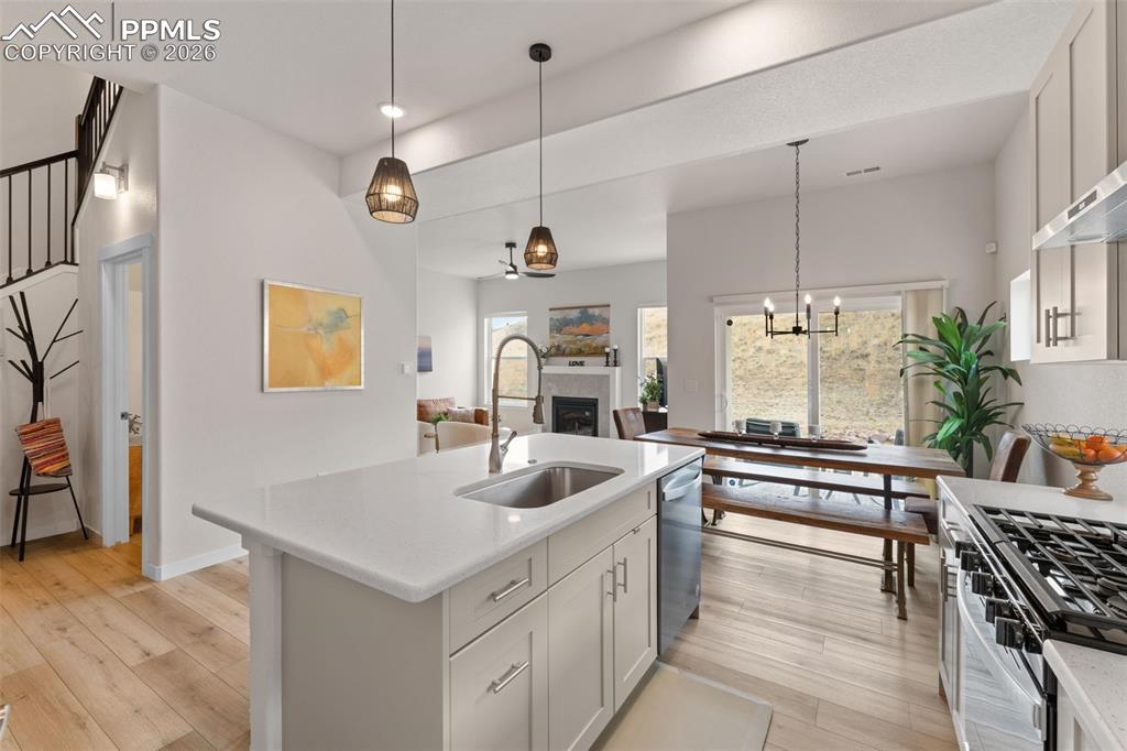 Image 8 of 42: Kitchen has large island and pendants
