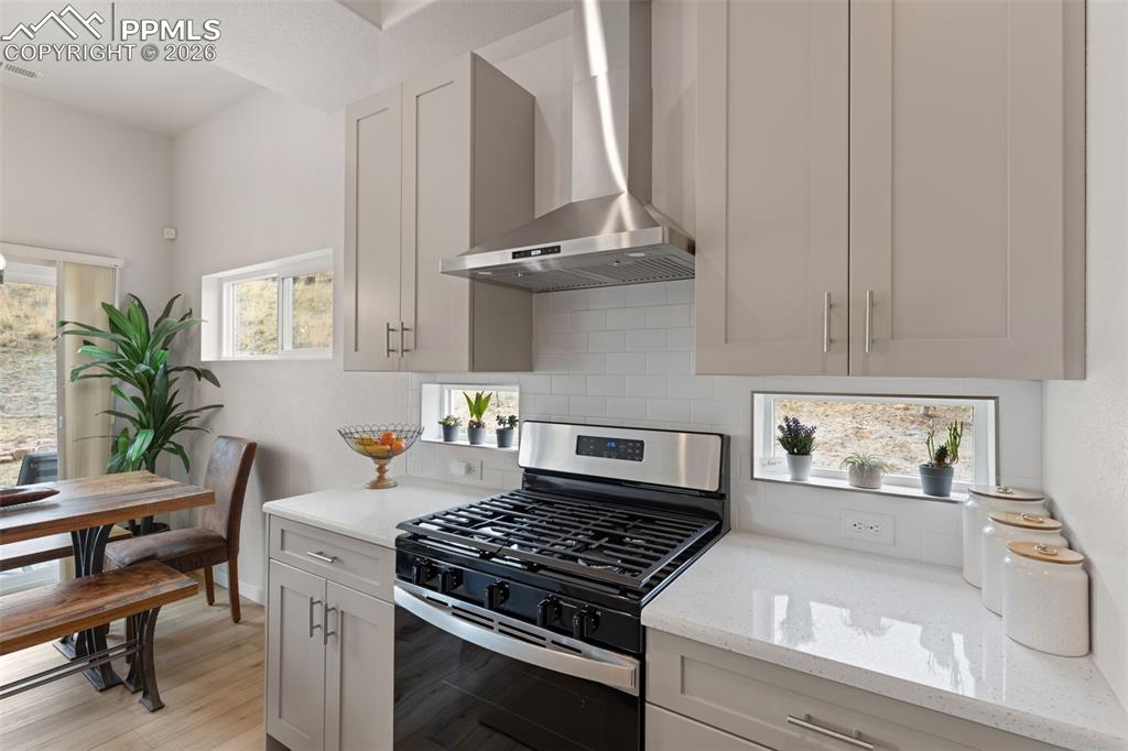 Image 9 of 42: Gas range and vented hood for your culinary needs