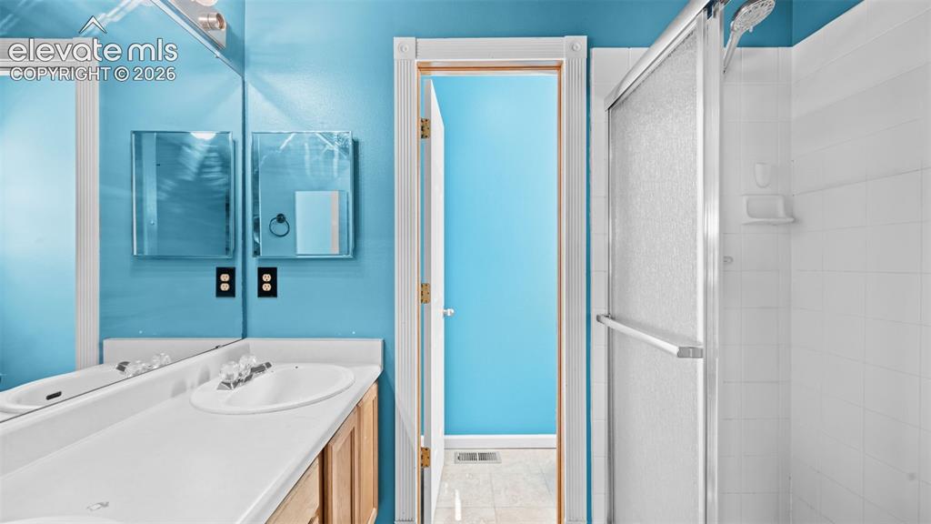 Image 18 of 33: Bright room featuring a single window with blinds, wood-finish flooring, an