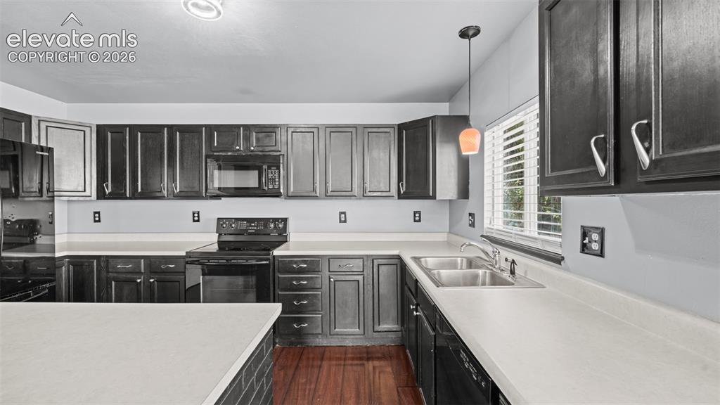 Image 9 of 33: Open concept living area featuring dark wood-finish flooring, a contemporar