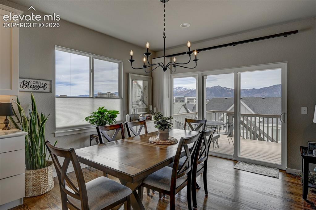 Image 11 of 29: Wood-finish flooring throughout, complemented by a multi-pane window and sl