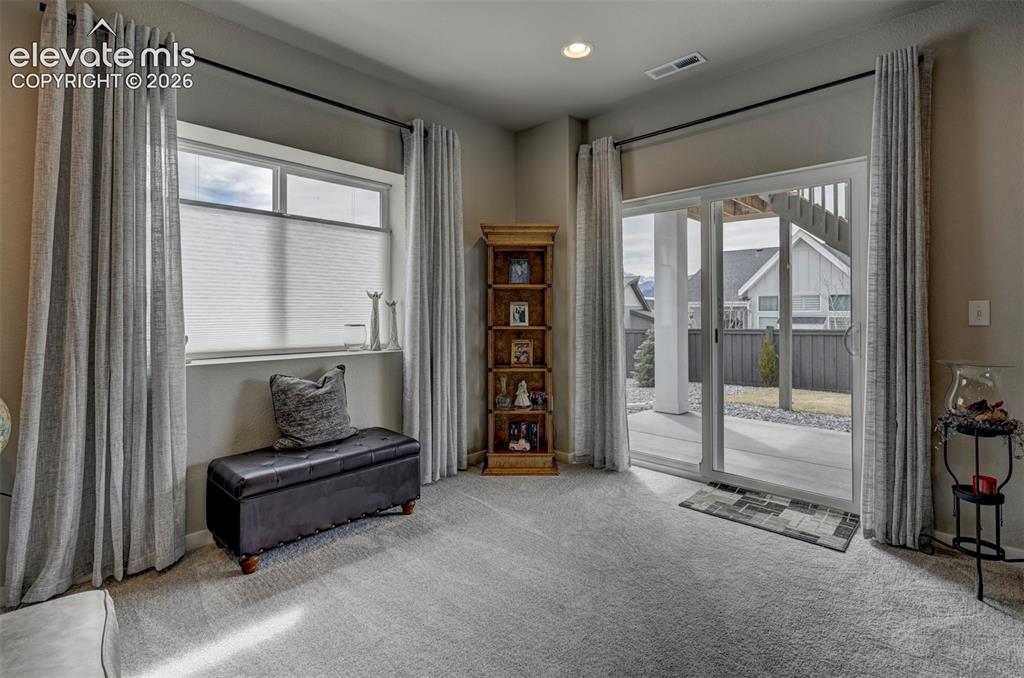 Image 21 of 29: Carpeted flooring, recessed lighting, expansive sliding glass door, and lar