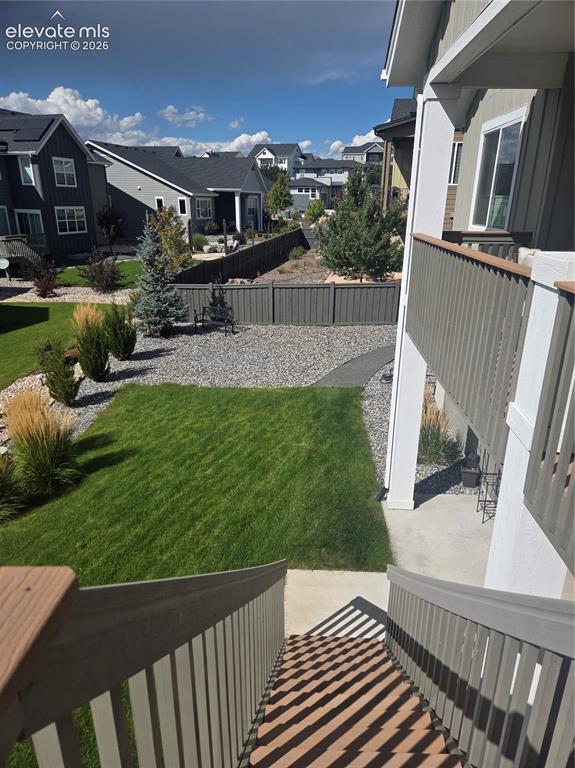 Image 26 of 29: Expansive green lawn, gravel landscaping, established trees and shrubs, pri