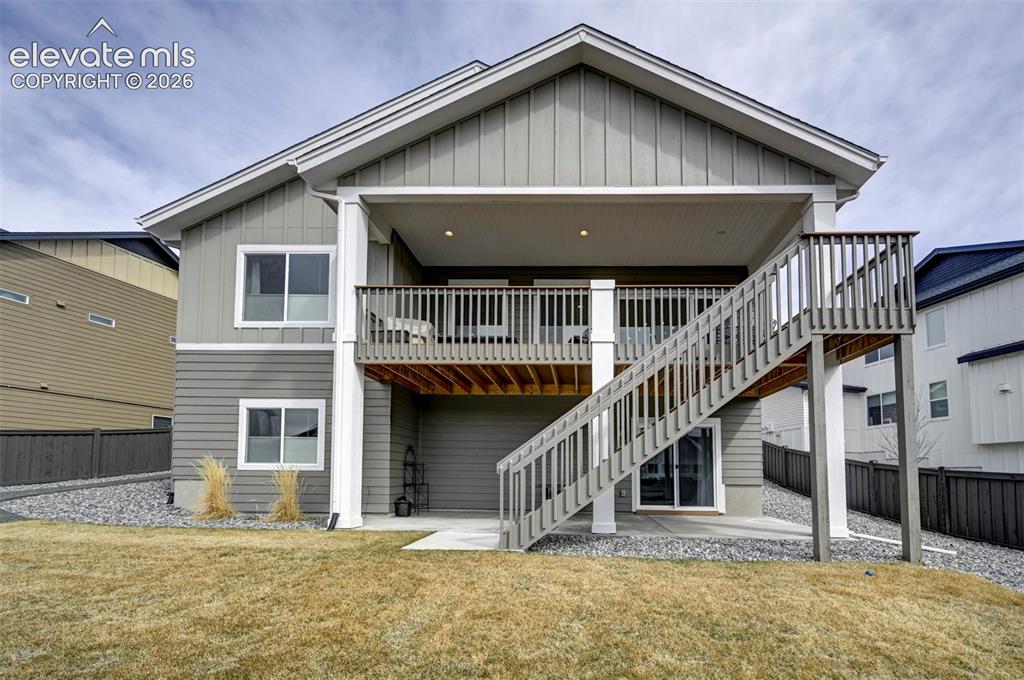 Image 29 of 29: Two-story exterior with a covered upper deck and lower patio