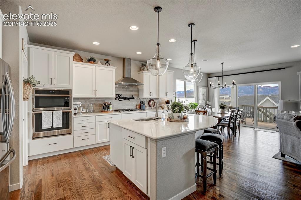 Image 6 of 29: Gourmet kitchen featuring white cabinetry, stainless steel appliances, and 