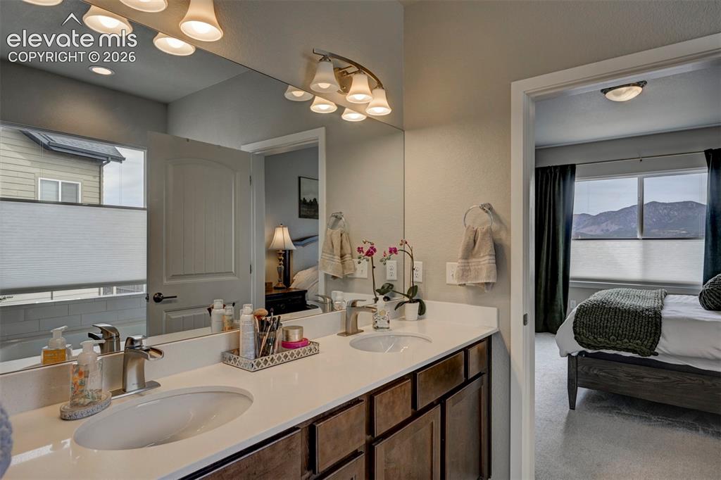 Image 9 of 29: Double vanity with undermount sinks, chrome fixtures, and wood-finish cabin
