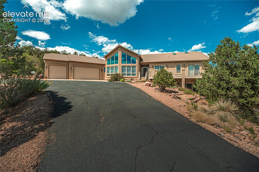 Image 1 of 50: Spacious multi-level residence featuring a prominent gabled roofline with e