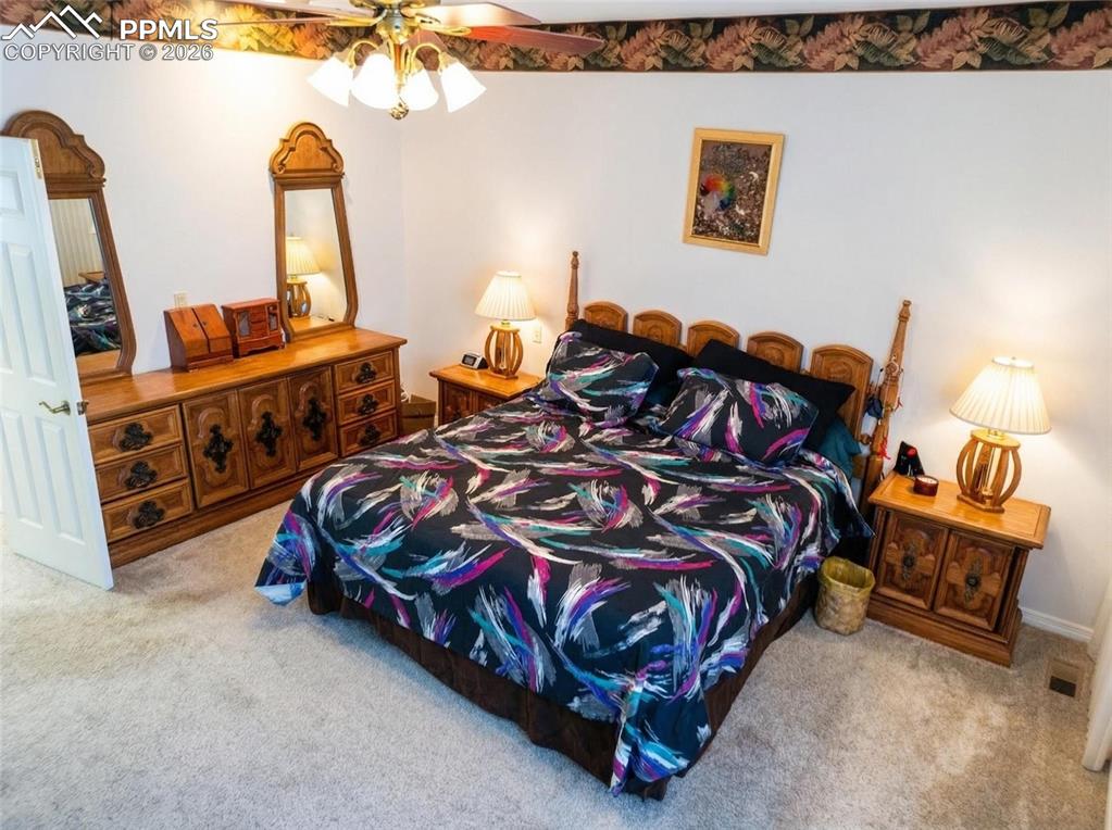 Image 14 of 30: Bedroom with light carpet and ceiling fan