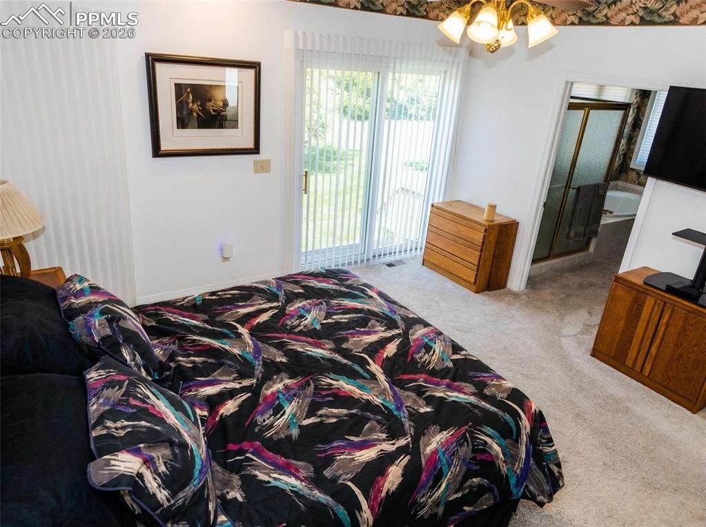 Image 15 of 30: Bedroom with light carpet, access to outside, and a ceiling fan