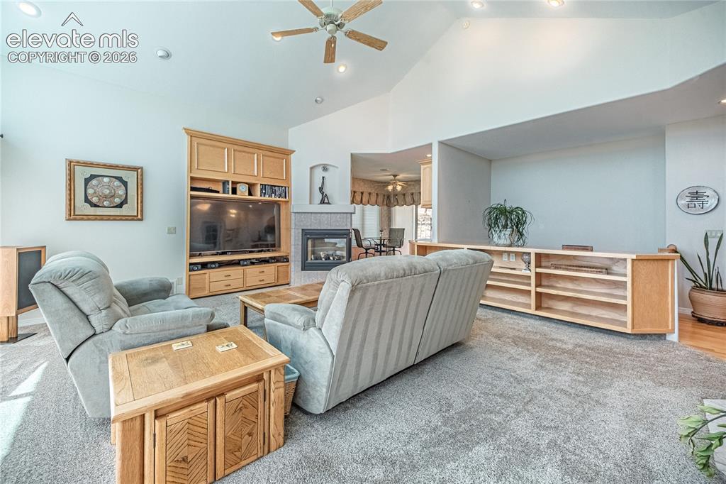 Image 15 of 50: Vaulted ceilings with recessed lighting and a ceiling fan