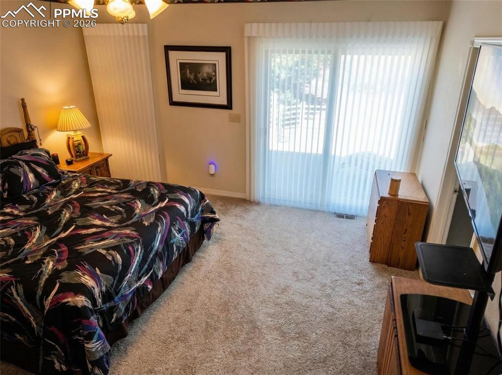Image 16 of 30: Bedroom featuring light carpet and a ceiling fan
