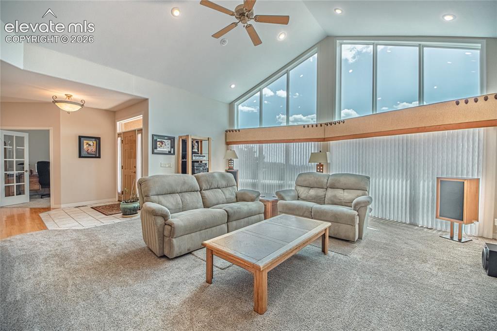 Image 16 of 50: Vaulted ceilings with recessed lighting, large transom windows, and a ceili