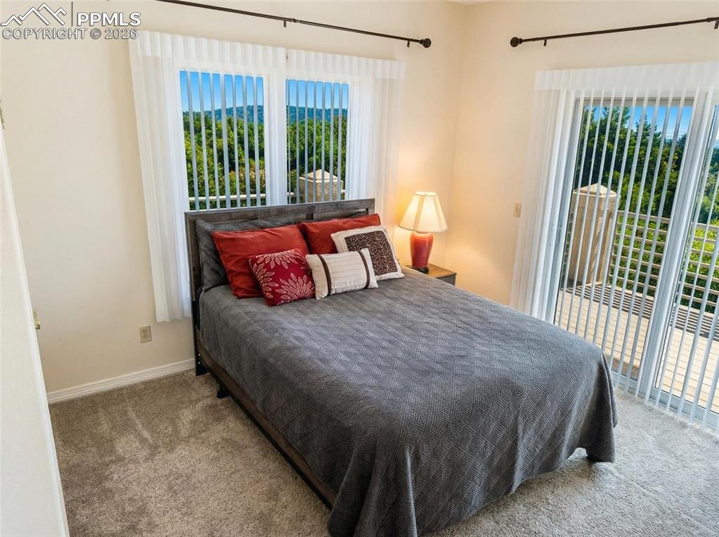 Image 19 of 30: Carpeted bedroom featuring access to exterior and baseboards