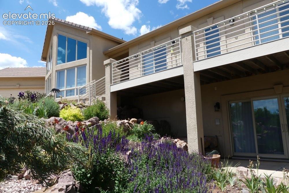 Image 2 of 50: Multi-level stucco exterior featuring an upper-level balcony with modern ho