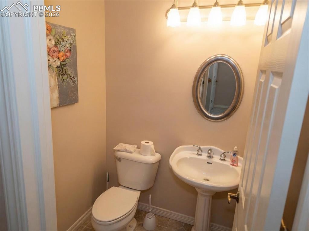 Image 22 of 30: Half bathroom featuring baseboards and tile patterned floors