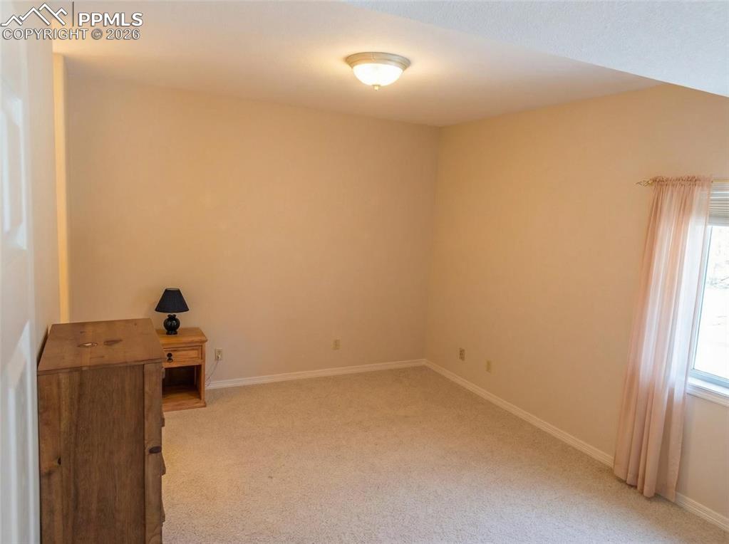 Image 29 of 30: Empty room with light carpet and baseboards