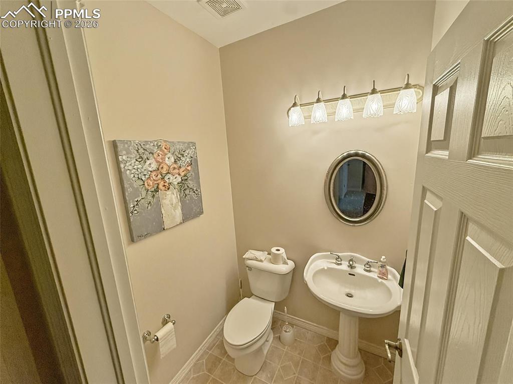 Image 33 of 38: Dual-Entry Bathroom featuring toilet and light tile patterned flooring
