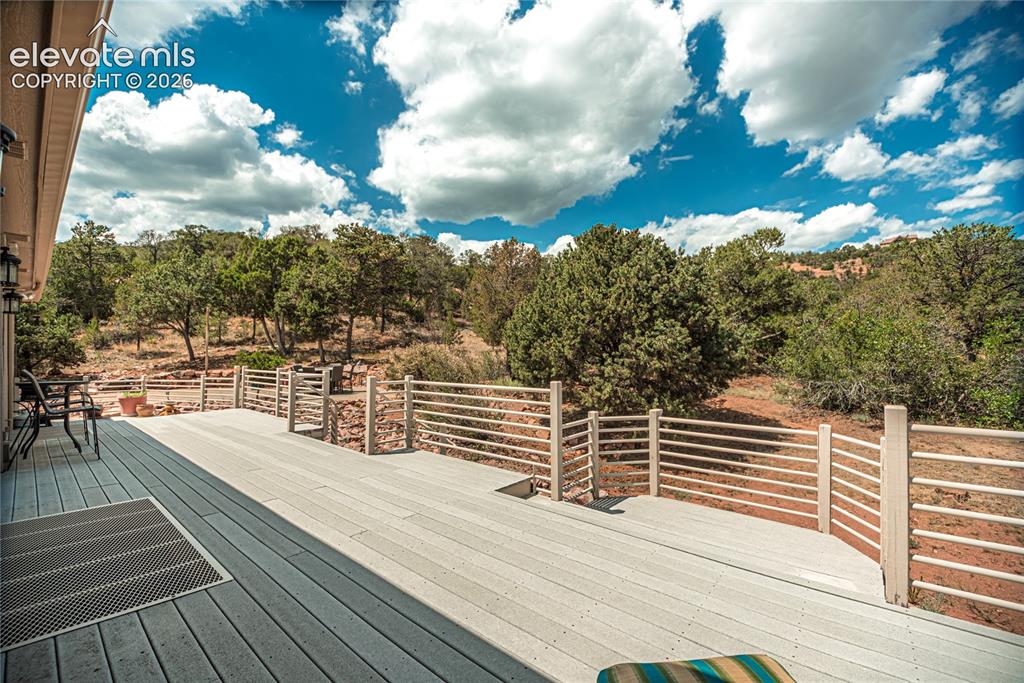 Image 4 of 50: Expansive outdoor deck featuring composite decking, a horizontal slat raili