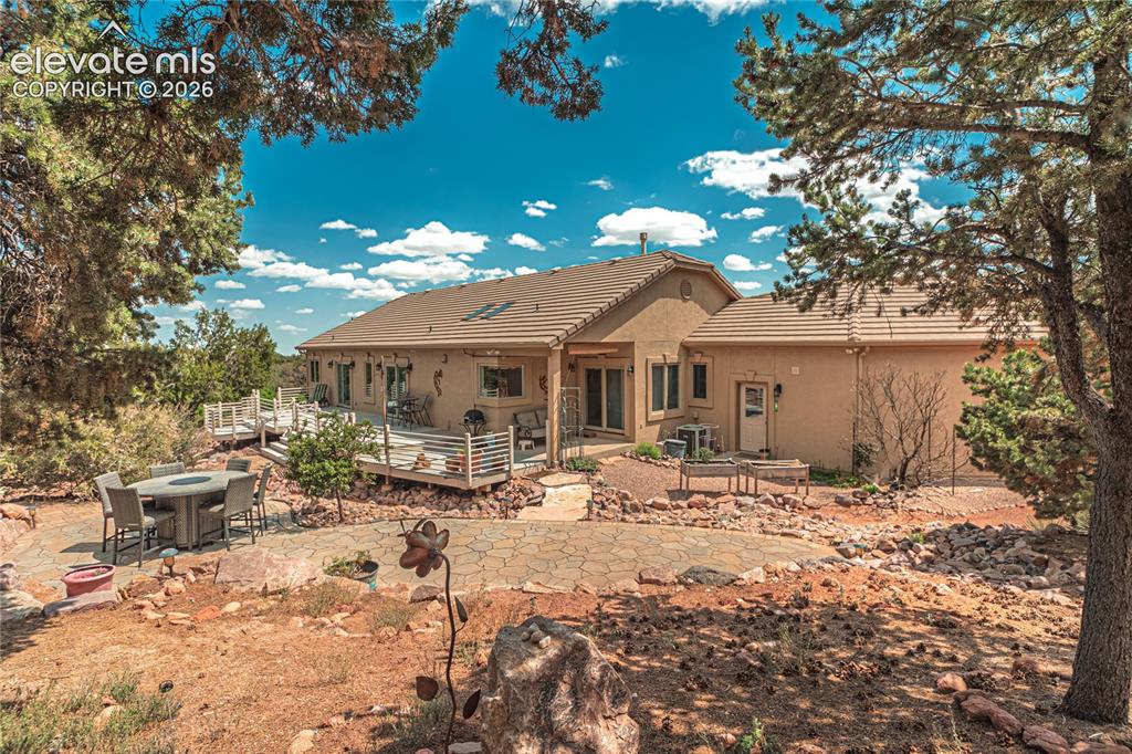 Image 5 of 50: Spacious stucco exterior featuring multiple elevated decks with white raili